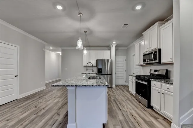a kitchen with microwave cabinets and stove top oven