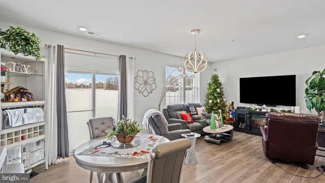a living room with furniture a flat screen tv and a large window