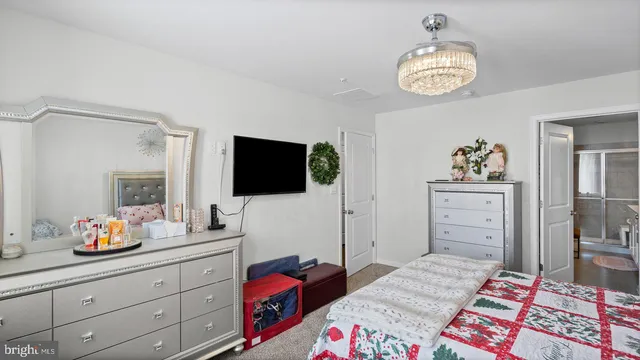 a bedroom with a bed and flat screen tv