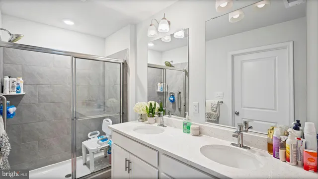a bathroom with a granite countertop sink a toilet and a mirror