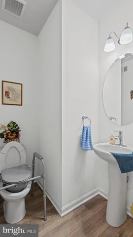 a bathroom with a toilet and a mirror