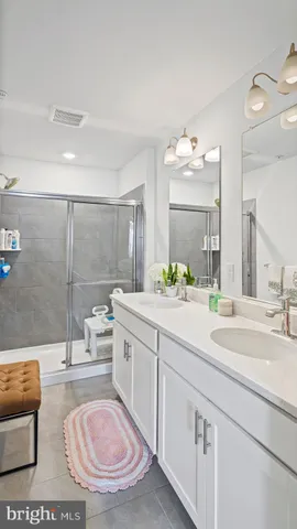 a bathroom with a sink double vanity and a mirror