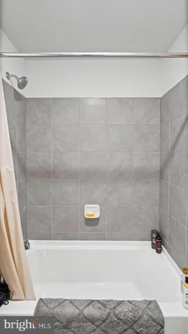 a bathroom with a bathtub and a shower