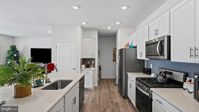 a kitchen with a sink a stove and a microwave