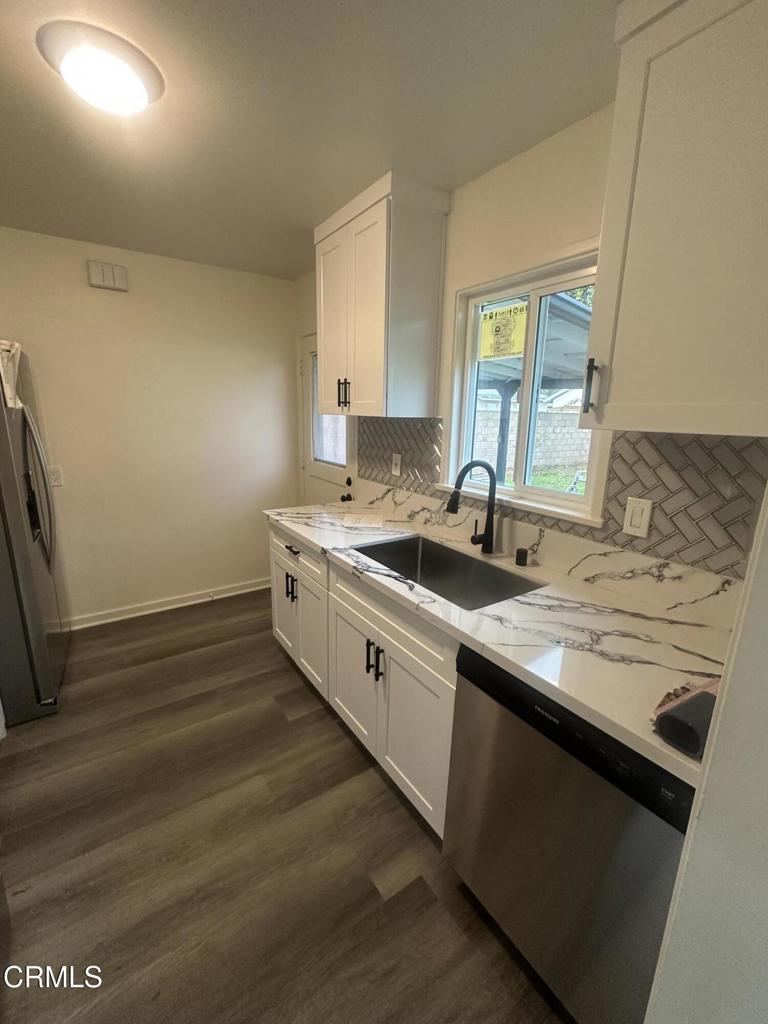 167 Hughes Drive Oxnard, CA 93033 - Photo 3 of 6 a kitchen with sink stove and cabinets