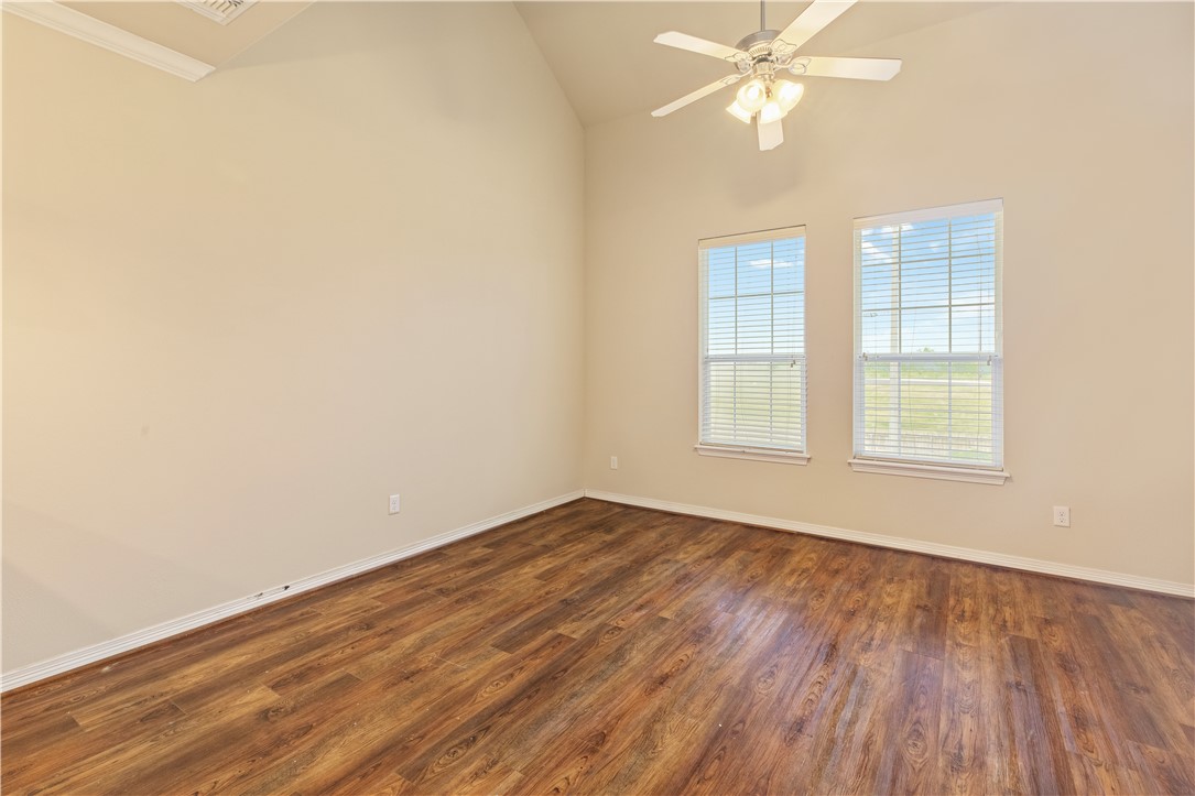 1198 Jones-Butler Road, Unit 1811 College Station, TX 77840 - Photo 2 of 26 an empty room with wooden floor fan and windows