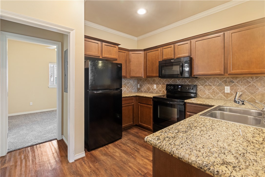 1198 Jones-Butler Road, Unit 1811 College Station, TX 77840 - Photo 5 of 26 a kitchen with a refrigerator stove and a sink