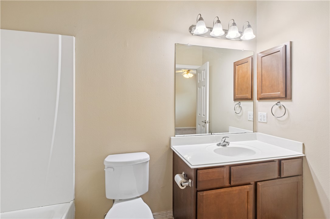 1198 Jones-Butler Road, Unit 1811 College Station, TX 77840 - Photo 7 of 26 a bathroom with a sink a toilet and mirror