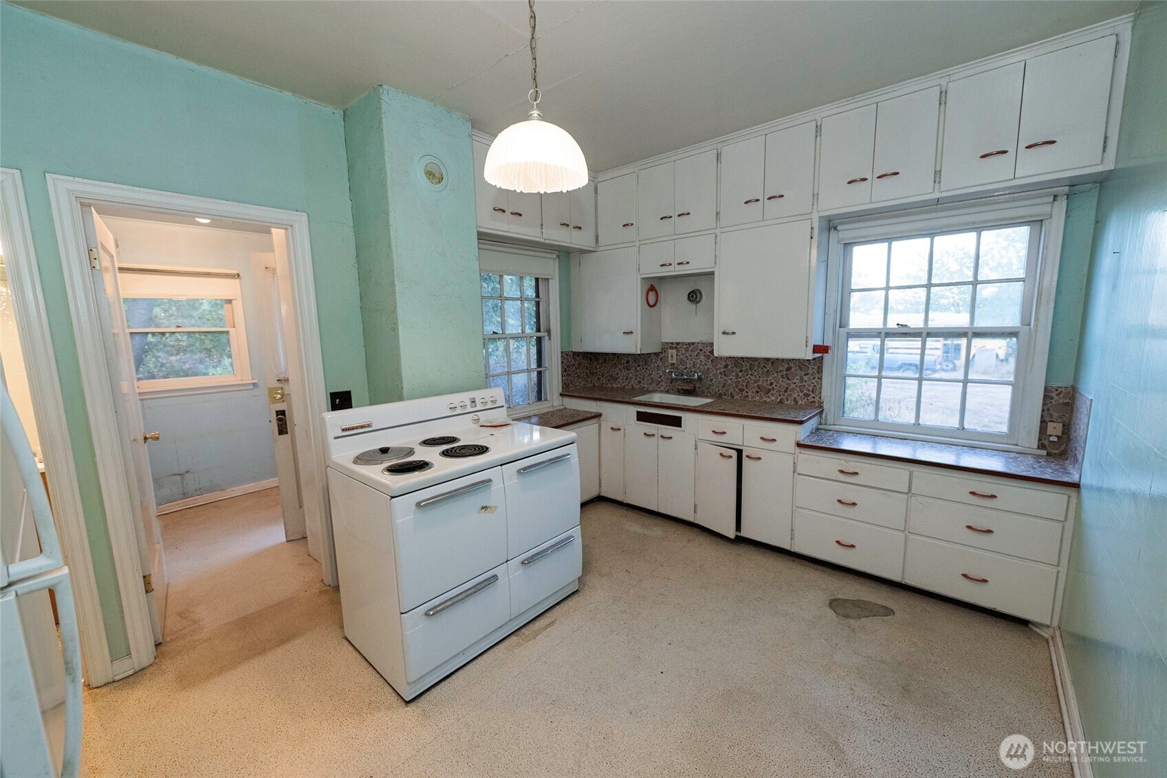 40 Northwest B Street College Place, WA 99324 - Photo 6 of 29 a kitchen with granite countertop white cabinets and white appliances