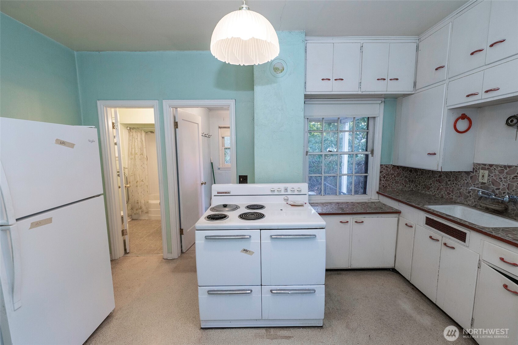 40 Northwest B Street College Place, WA 99324 - Photo 7 of 29 a kitchen with a sink a refrigerator a stove and white cabinets