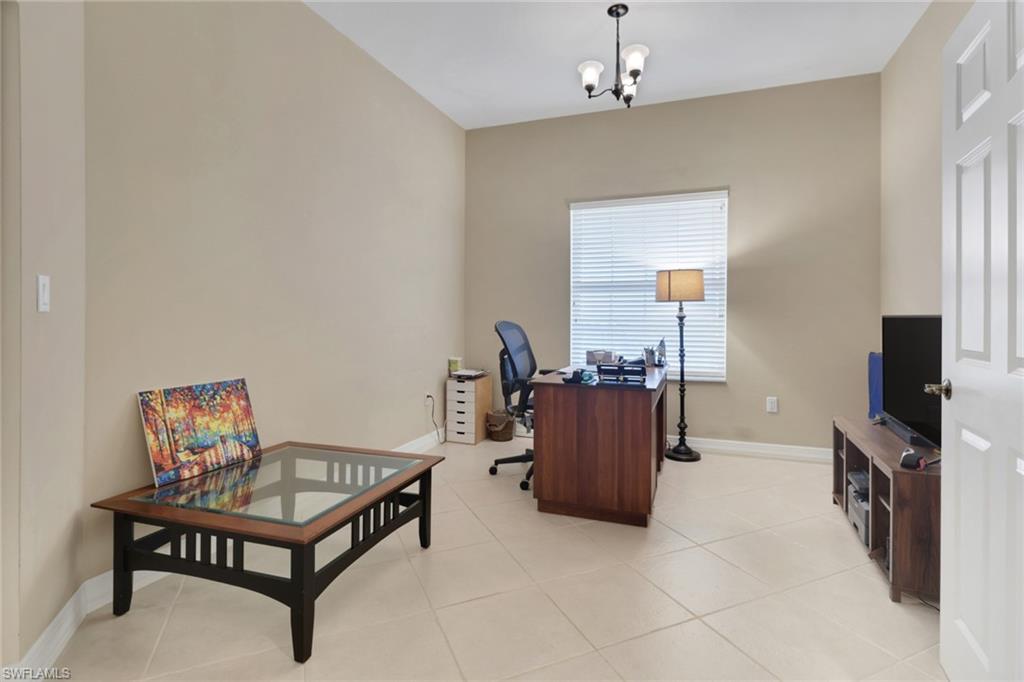 450 Bayfront Place, Unit 4509 Naples, FL 34102 - Photo 13 of 24 Office area with light tile patterned floors and a chandelier