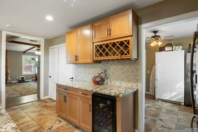 a kitchen with stainless steel appliances granite countertop a sink and cabinets