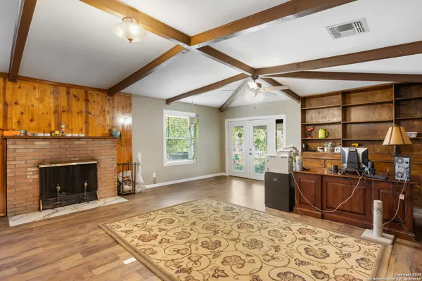 a living room with fireplace furniture and a fireplace