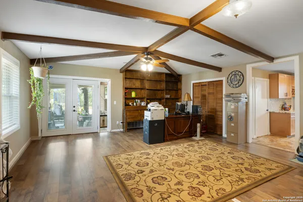 a room with wooden floor and furniture