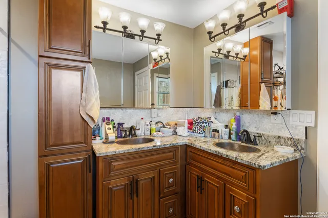 a bathroom with a sink and a mirror