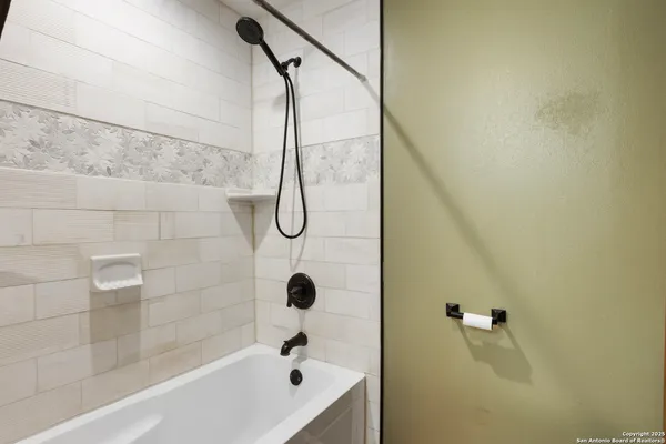 a bathroom with a shower and a bathtub