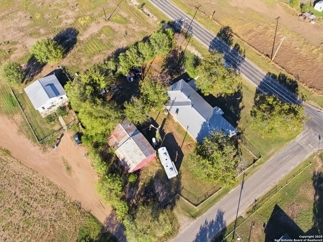 a aerial view of a house with a yard and garden