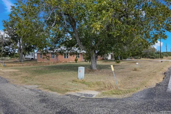 a view of a fire pit with large trees