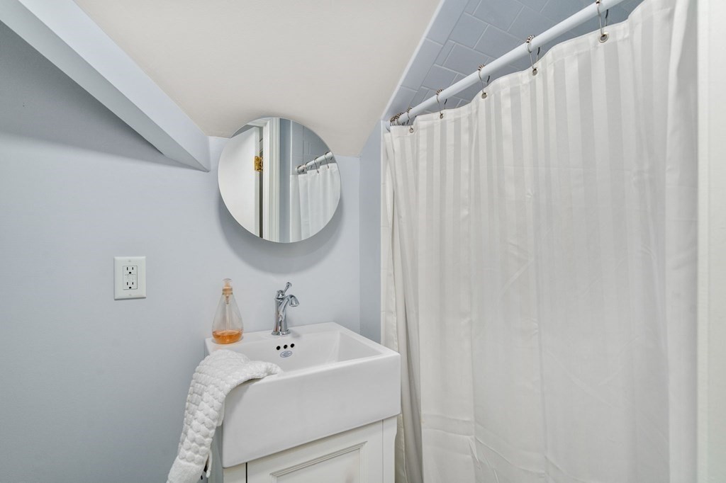91 Fayette Street, Unit 91 Watertown, MA 02472 - Photo 17 of 21 a bathroom with a sink and a mirror