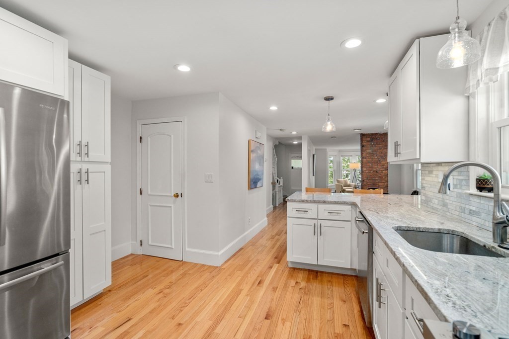 91 Fayette Street, Unit 91 Watertown, MA 02472 - Photo 10 of 21 a large kitchen with kitchen island a sink stainless steel appliances and cabinets