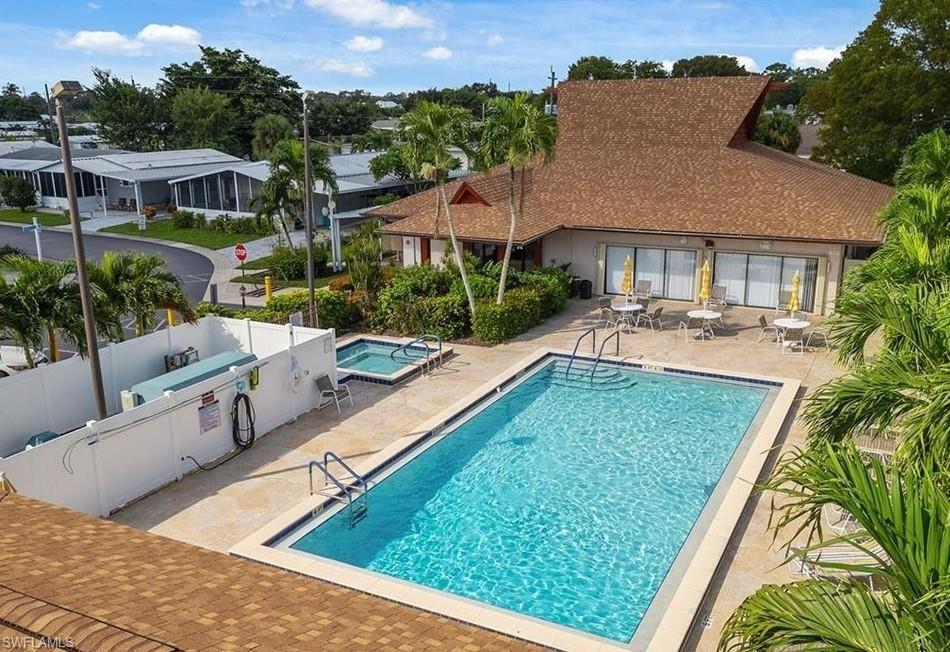 76 Atlantic Way, Unit 76 Naples, FL 34104 - Photo 5 of 18 a view of a house with pool plants and trees