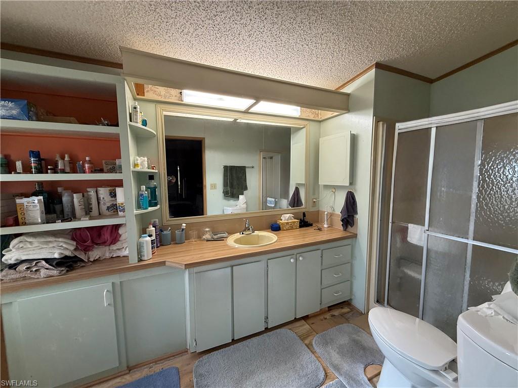76 Atlantic Way, Unit 76 Naples, FL 34104 - Photo 10 of 18 a bathroom with a sink a toilet and a mirror