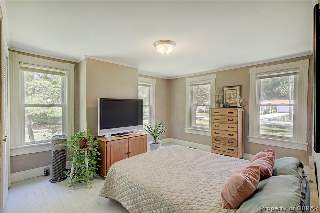 2442 Old Ferry Road Hudgins, VA 23076 - Photo 16 of 33 Bedroom with crown molding, multiple windows, and hardwood / wood-style floors