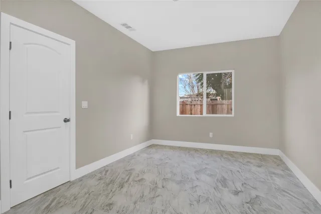 an empty room with windows and closet