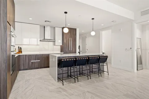 a kitchen with stainless steel appliances a stove and cabinets
