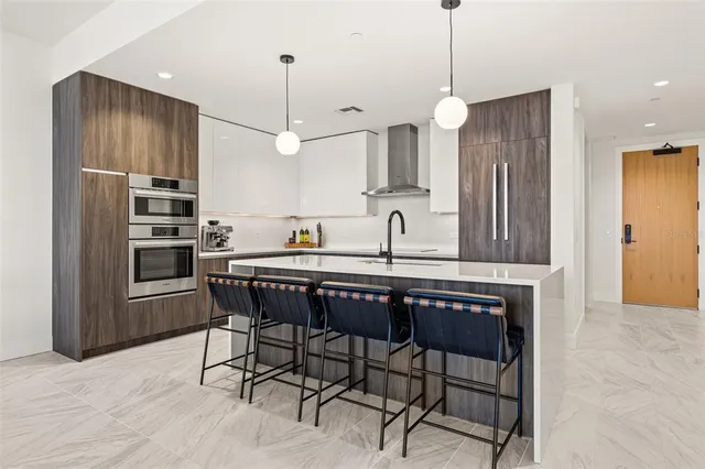 a kitchen with a sink dishwasher a stove and a refrigerator with wooden floor