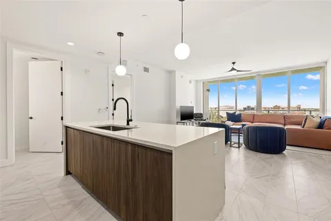 a kitchen with kitchen island a sink stainless steel appliances and cabinets