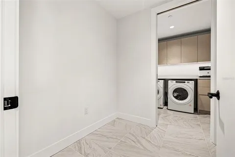 a view of a closet with wooden floor