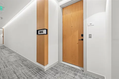 a view of a kitchen with a sink and a refrigerator