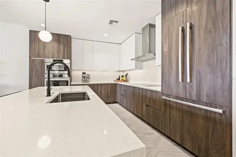 a kitchen with stainless steel appliances a sink and a refrigerator