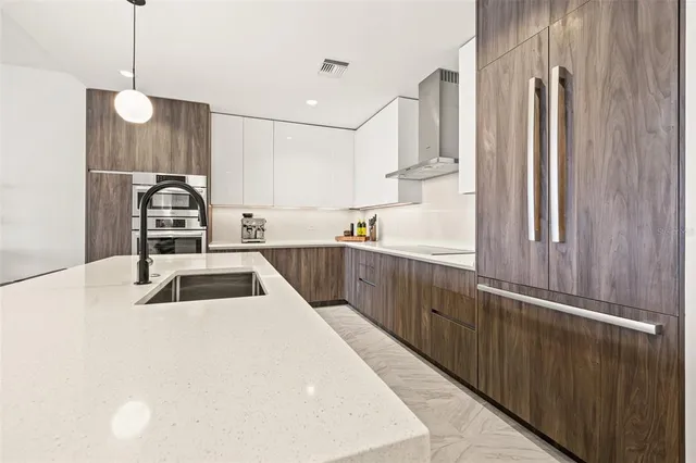a kitchen with stainless steel appliances a sink and a refrigerator