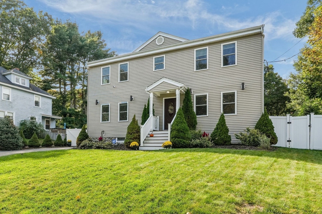 a front view of house with yard and outdoor seating