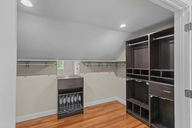 a view of walk in closet with clothes and shoes