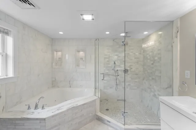 a bathroom with a bathtub and a shower