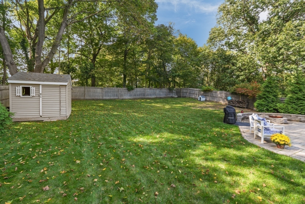 51 Faxon Street Braintree, MA 02184 - Photo 20 of 31 a backyard of a house with trees and wooden fence