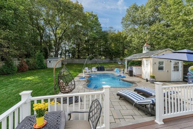 a view of house with backyard and furniture