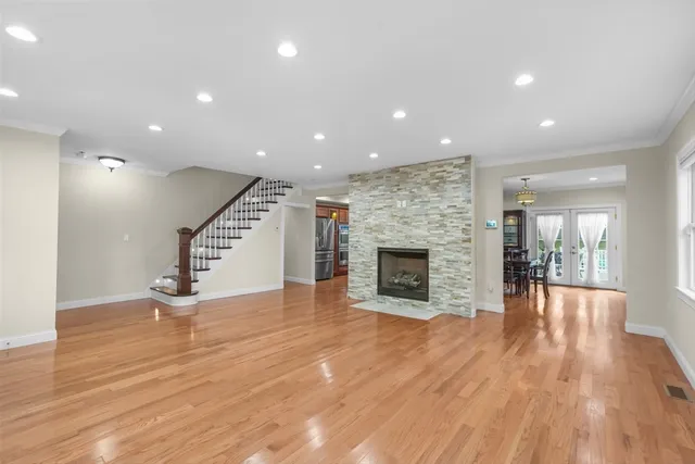 a view of empty room with wooden floor and fireplace