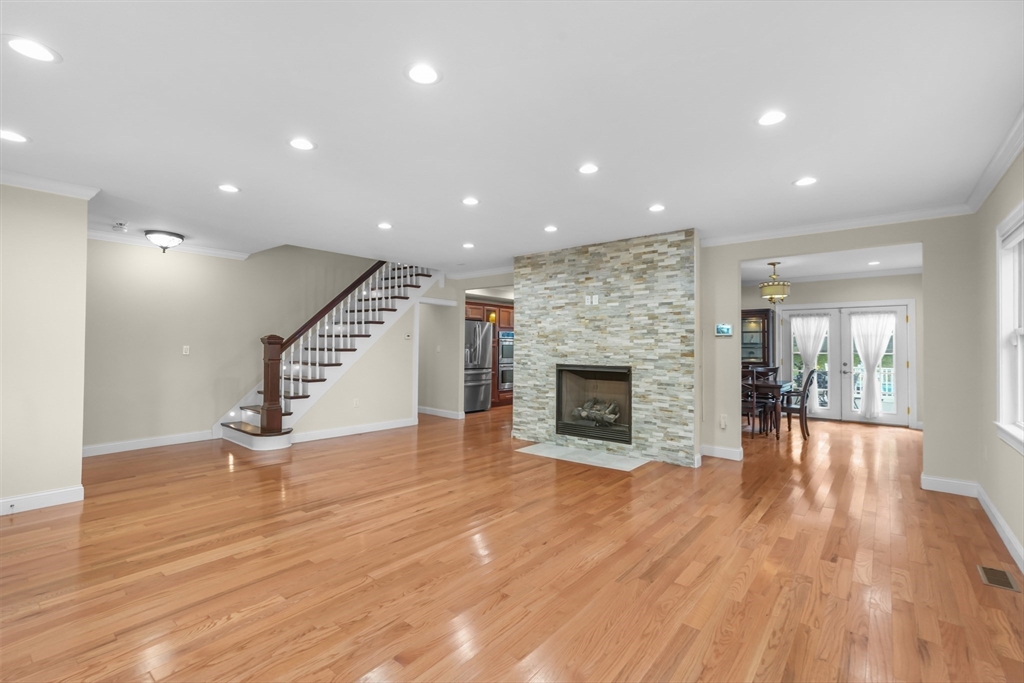 51 Faxon Street Braintree, MA 02184 - Photo 5 of 31 a view of empty room with wooden floor and fireplace
