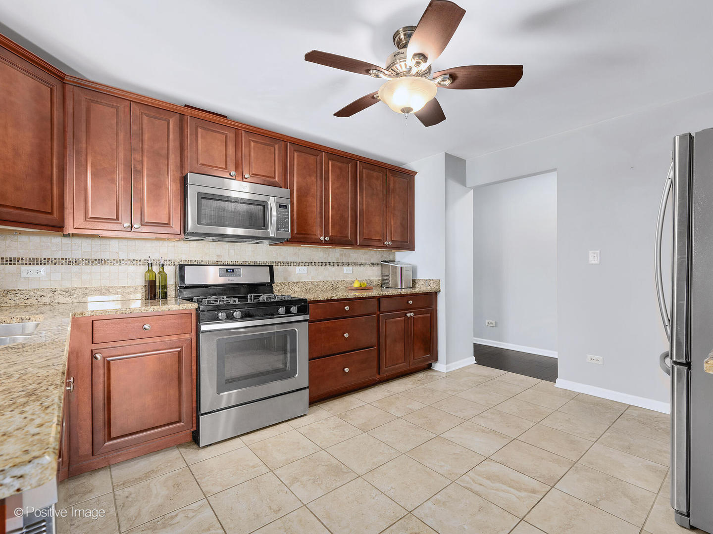 1517 Sequoia Lane Darien, IL 60561 - Photo 11 of 27 a kitchen with stainless steel appliances granite countertop a stove cabinets and a refrigerator