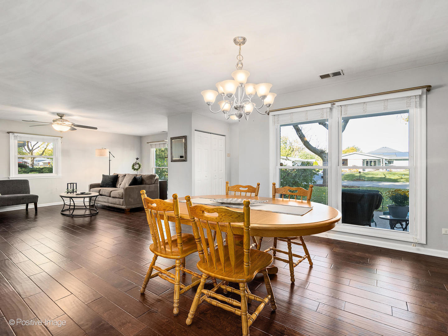 1517 Sequoia Lane Darien, IL 60561 - Photo 8 of 27 a dining room with wooden floor a chandelier a glass table and chairs