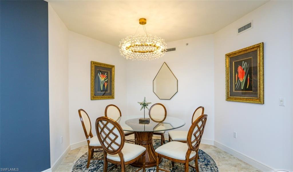 1060 Borghese Lane, Unit 603 Naples, FL 34114 - Photo 30 of 50 Dining room featuring baseboards, visible vents, and an inviting chandelier