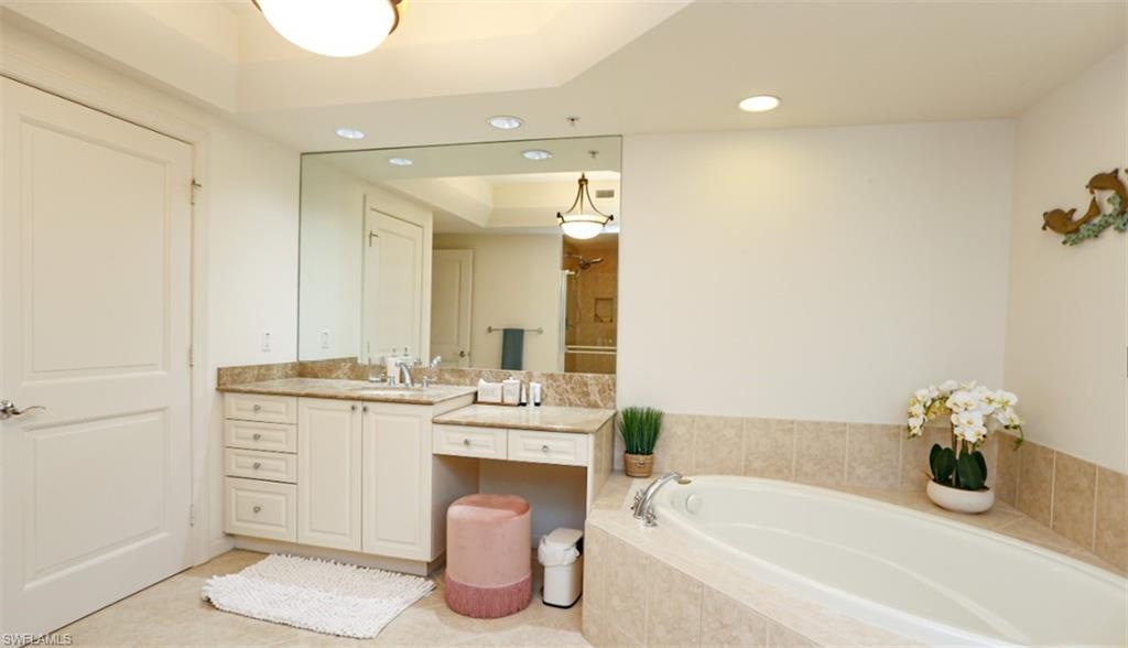 1060 Borghese Lane, Unit 603 Naples, FL 34114 - Photo 50 of 50 Full bathroom featuring walk in shower, recessed lighting, vanity, a tray ceiling, and a garden tub