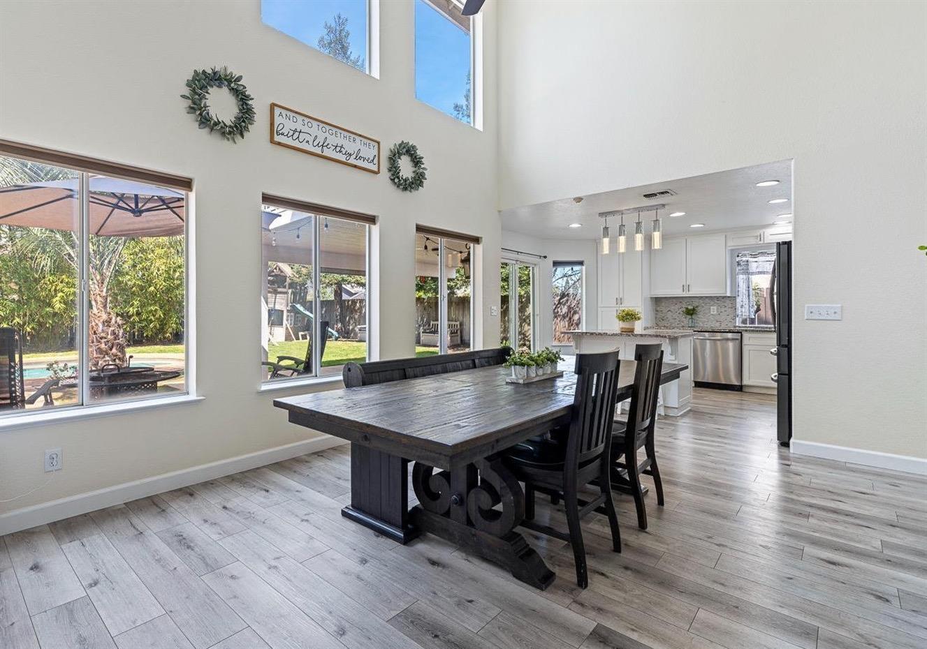 3232 Greenfield Avenue Clovis, CA 93611 - Photo 16 of 38 a dining room with stainless steel appliances kitchen island a table and chairs in it