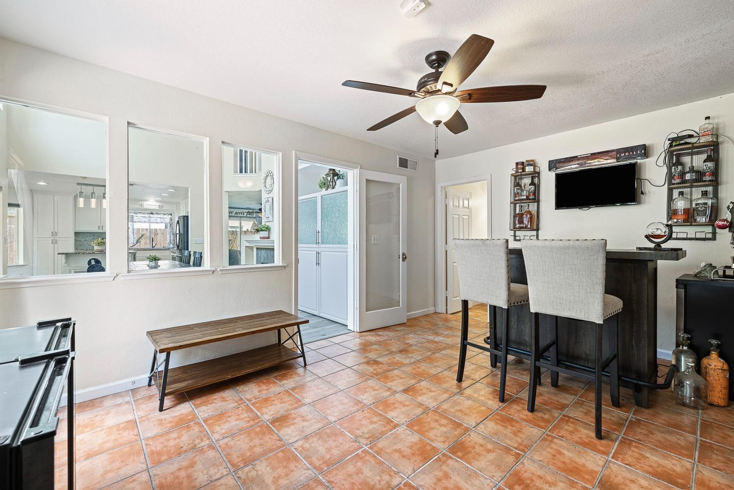 3232 Greenfield Avenue Clovis, CA 93611 - Photo 17 of 38 a living room with furniture a flat screen tv and a window