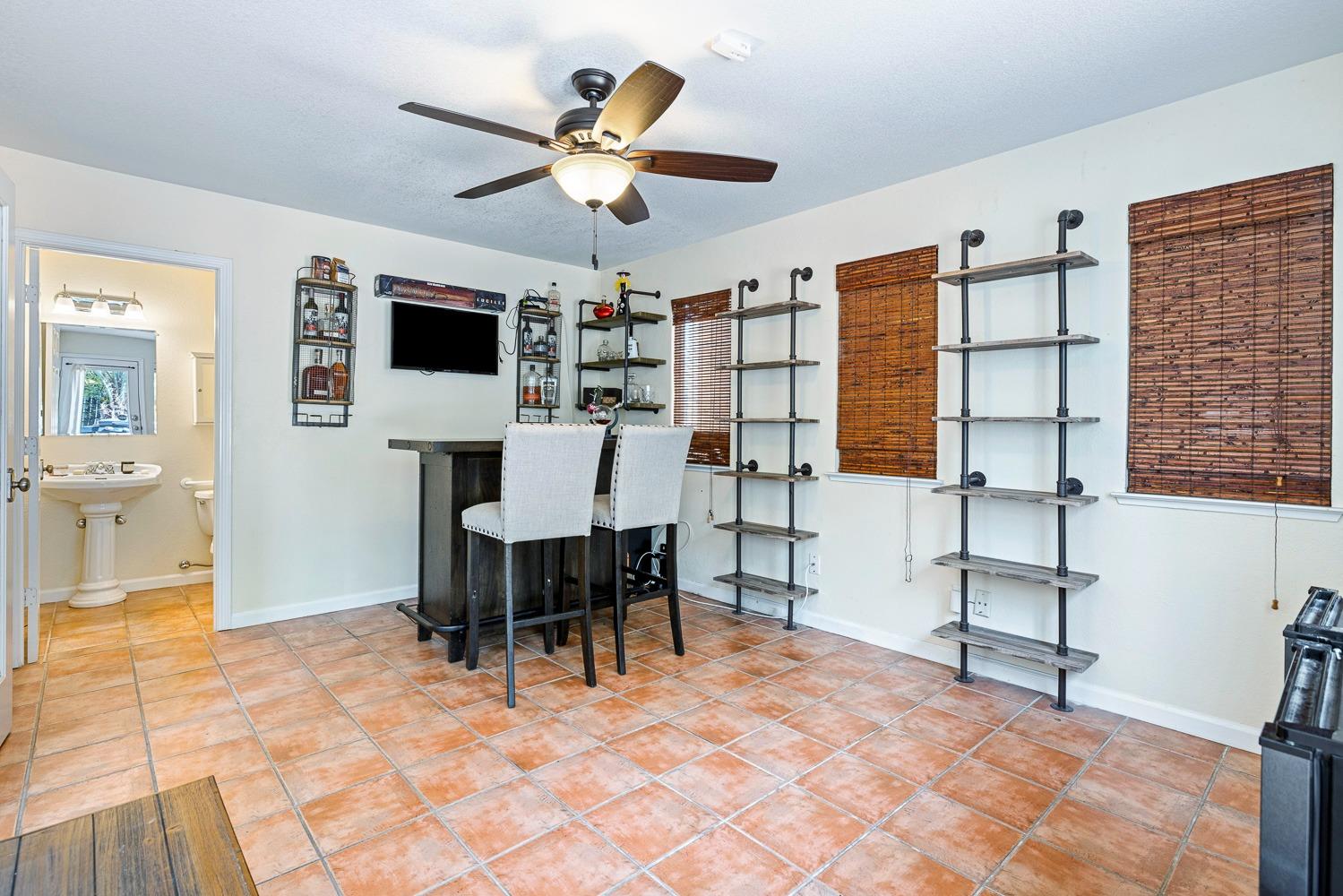 3232 Greenfield Avenue Clovis, CA 93611 - Photo 18 of 38 a view of a livingroom with furniture and a ceiling fan