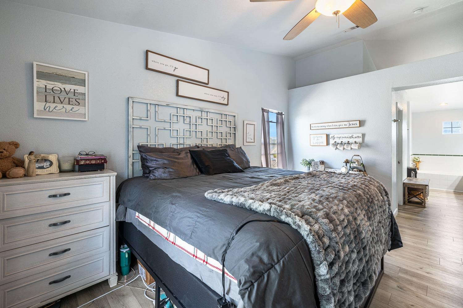 3232 Greenfield Avenue Clovis, CA 93611 - Photo 23 of 38 a bedroom with a bed and wooden floor